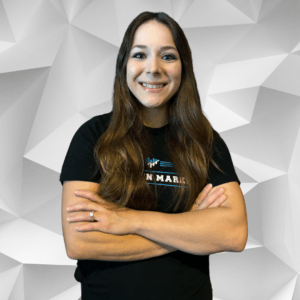 Grow Pro Agency- About us- Sammy Clark stands smiling with her arms crossed